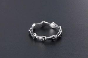 Close-up of gothic silver spine ring featuring brushed titanium steel bone textures