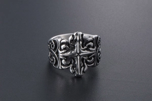 Macro detail of Gothic titanium steel ring with cross motif and ornate scroll engravings