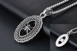 Macro view of vintage oval pendant with hollow eight-pointed star and scalloped edges