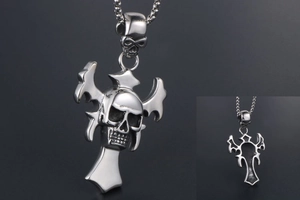 Macro shot of gothic skull cross pendant featuring detailed silver steel engravings