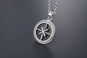 Close-up of titanium steel octagonal star pendant with Greek fret pattern on round chain