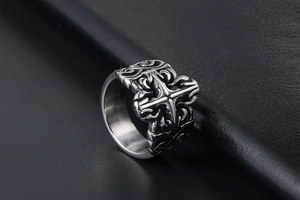 Macro detail of gothic cross relief and scrollwork pattern on vintage titanium steel ring