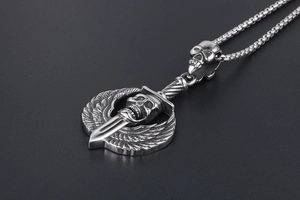Close-up of gothic skull pendant with wings and sword on a silver box chain
