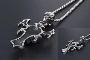 Macro detail of gothic skull cross pendant with vintage silver finish and box chain