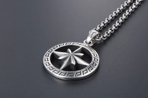 Macro shot of titanium steel round pendant with Greek key pattern and octagonal star star