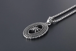 Detail of vintage silver octagonal star pendant with intricate engraved borders