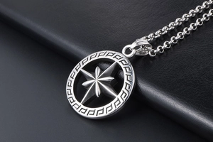Close-up of retro titanium steel octagonal star pendant with Greek fret patterns