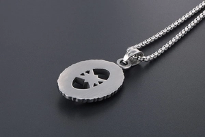 Macro detail of silver star pendant with brushed metal finish and hollow octagonal design