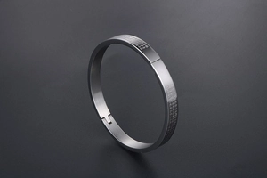 Macro shot of silver titanium steel cuff bracelet with Heart Sutra engraving detail