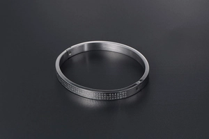 Close-up of matte silver titanium steel bangle with engraved Heart Sutra scripture