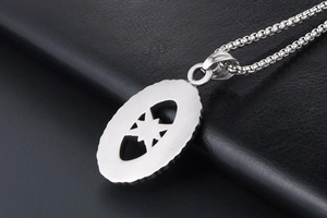 Close-up of silver hollow star pendant with brushed metal texture on black leather background