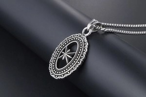 Macro side view of hollow octagonal star pendant with vintage bead edge and bead chain