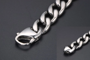 Detail of silver titanium steel Cuban link bracelet with high-polish lobster clasp