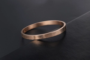 Close-up of rose gold titanium steel bracelet with engraved Heart Sutra text