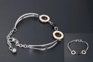 Detailed view of tricolor adjustable bracelet with rose gold rings and black bead charm