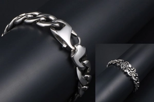 Detailed close-up of gothic stainless steel cuban chain bracelet with fleur-de-lis carving
