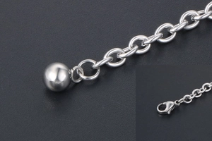Detail of silver link chain with round ball pendant and sturdy lobster clasp closure