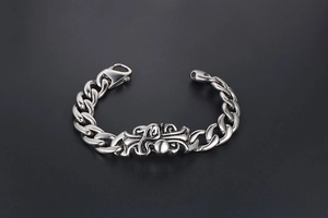 Macro shot of vintage titanium steel chain bracelet with ornate cross emblem detail