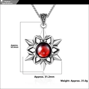 Detailed view of vintage star pendant with red stone, dimensions 50.8mm by 31.2mm