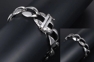 Detail view of silver steel snake chain bracelet featuring H shaped clasp and textured links