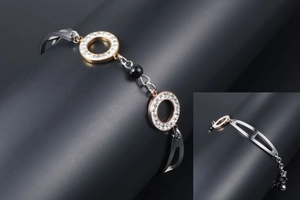 Detail of rose gold and silver mixed metal bracelet featuring black beads and rhinestones