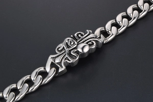 Close-up of titanium steel curb chain bracelet with retro punk engraved floral motif
