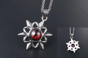 Macro detail of star pendant showing red gemstone and solid metal back construction