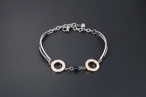 Detail of rose gold double interlocking rings with crystals and a black bead on a chain