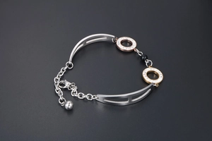 Detail of rose gold and black obsidian bead bracelet with sparkling rhinestone rings
