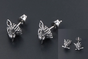 Macro detail of wolf head stud earrings with sword accent in silver punk style