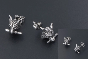 Macro detail of gothic wolf head studs with silver finish and intricate fur textures