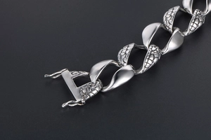 Macro shot of silver men's snake scale link bracelet with secure double-lock box clasp