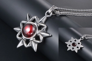 Close-up of vintage steel hexagram necklace with red gemstone and aged metal finish
