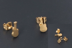 Close-up of gold-plated guitar stud earrings with secure butterfly backs and metal texture