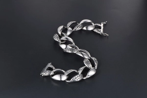 Detail of men's heavy metal snake scale chain bracelet with retro gothic finish