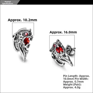 Macro detail of men's stainless steel lion head earrings with red crystal eyes and vintage finish