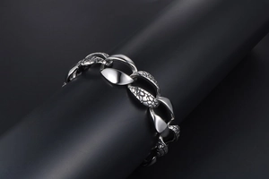 Detailed close-up of heavy metal snake texture links on a silver industrial style bracelet