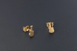Macro view of gold guitar stud earrings made of titanium steel with a sleek matte finish