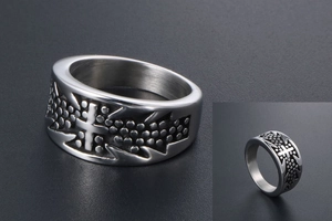Detailed view of punk titanium steel ring with embossed cross and textured dotted pattern