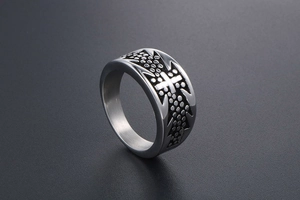 Detailed macro view of titanium steel cross ring with dotted relief and gothic texture
