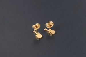 Detail view of gold-plated guitar stud earrings featuring a polished metallic finish