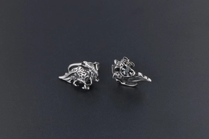 Detailed view of gothic lion stud earring with vintage silver finish and black gemstone