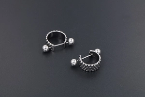 Close-up of punk style titanium steel earrings with unique non-slip texture detail