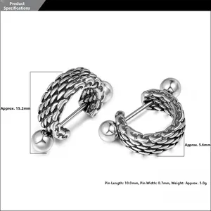 Macro shot of titanium steel hoop earrings with retro woven texture and vintage silver finish