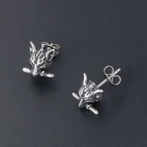 Vintage wolf head stud earrings in punk style with detailed carvings and metallic texture
