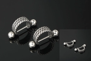 Detail of silver twist texture punk stud earrings with screw ball ends for men and women