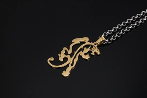 Detailed view of a gold lion silhouette pendant on a thick silver chain with reflection
