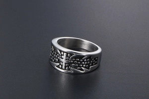 Detailed shot of retro titanium steel cross ring with embossed dot texture