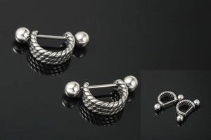 Macro shot of stainless steel twisted rope U-shaped nipple shield with ball closure detail