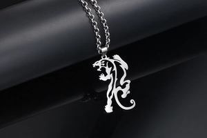 Detail of silver roar tiger silhouette pendant on a black cylinder display stand